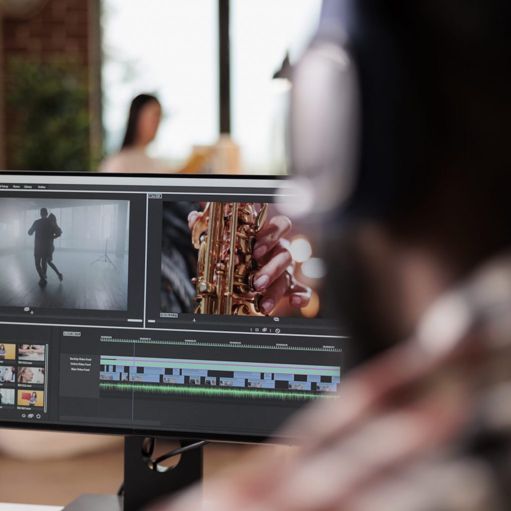 Young freelancer editing footage on software, working to edit video montage with color grading and audio effects. Sound and film production content, making creative movie on computer.